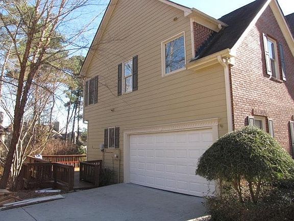 Side Entry Garage and gate to HUGE deck in back of the house