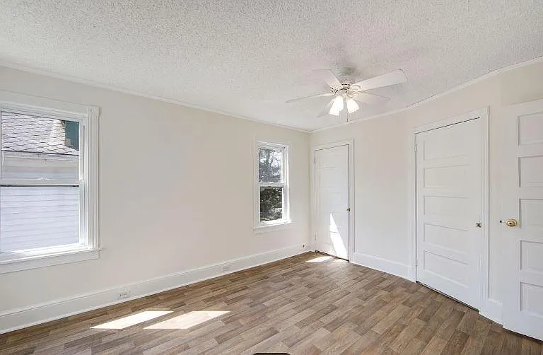 Master bedroom with 2 walk in closets and shelving and a 3rd closet for plenty of storage