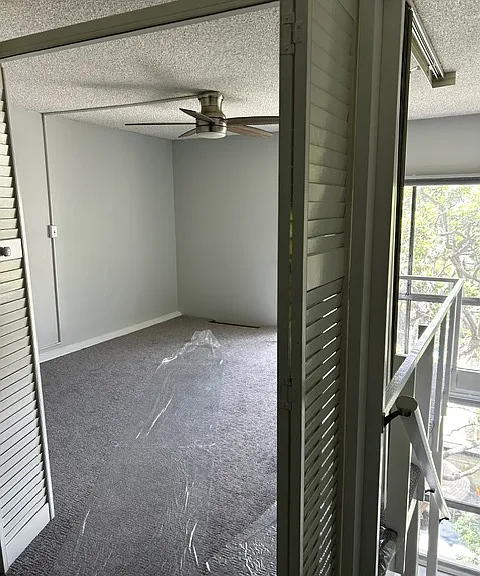 Larger loft bedroom with ceiling fan.