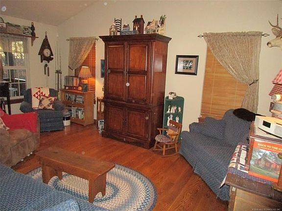 Large Living and Dining combination with hardwood floors and lots of windows overlooking wooded back yard