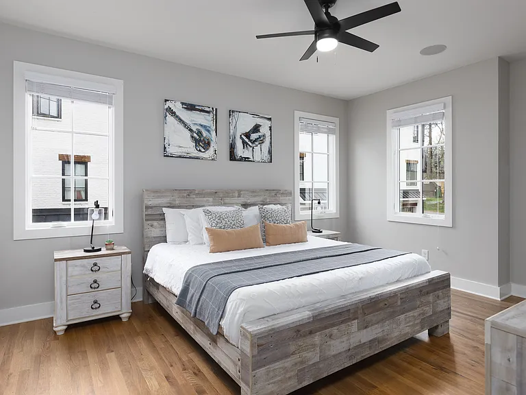 Primary bedroom on the 2nd floor with a king bed, Smart TV, ensuite bath, and room darkening shades. Includes a large walk-in closet. Tastefully decorated with high-end modern furnishings.