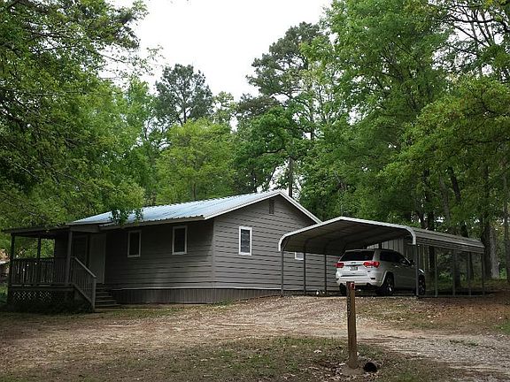 Front of house with carport on 3/4 acre of land