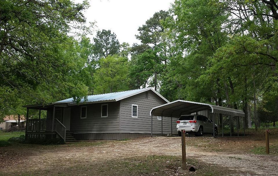 Front of house with carport on 3/4 acre of land