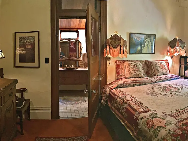 Bedroom Panorama Photo with Bathroom Entrance in center of photo.