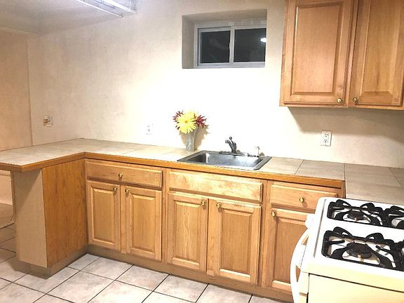 Kitchen with Gas Appliances, Microwave & Refrigerator