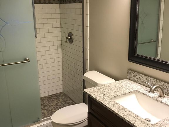 Newly remodeled bathroom- shower w/ subway tiles, granite counter tops, and new tile planked flooring.