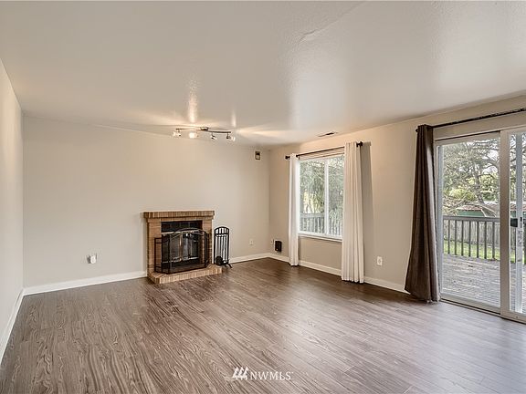 Spacious living room with newer laminate flooring, fresh interior paint and cozy. 