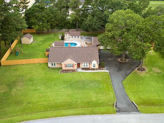 Sweeping lawn with stately trees all around.
