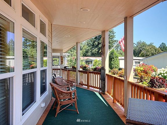 Imagine relaxing on this spacious covered deck sipping your morning coffee and visiting with the neighbors passing by.>