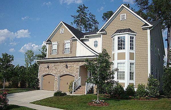 Home with beautiful landscaping and stone front