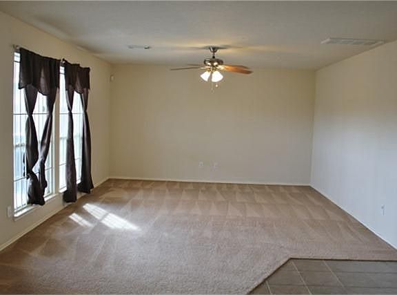 Den area is large and has nice big windows for natural light.