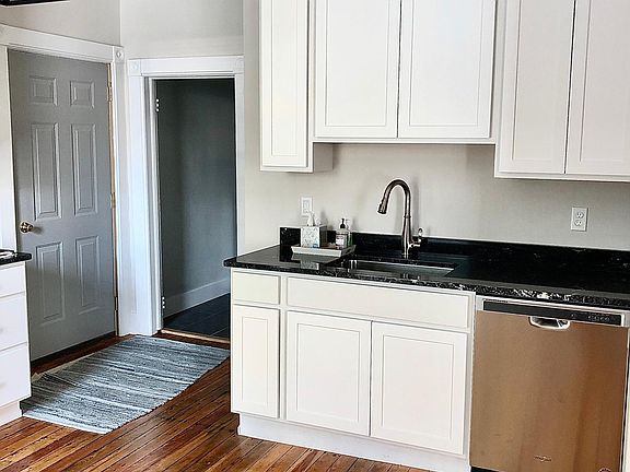 Spacious kitchen with over-sized cabinets, stainless appliances (dishwasher, stove and refrigerator).