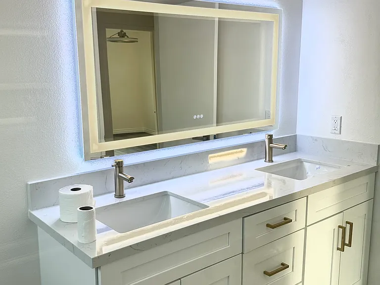 Fully renovated hallway bathroom for the second floor with led light mirror, double sink vanity in modern gold tones