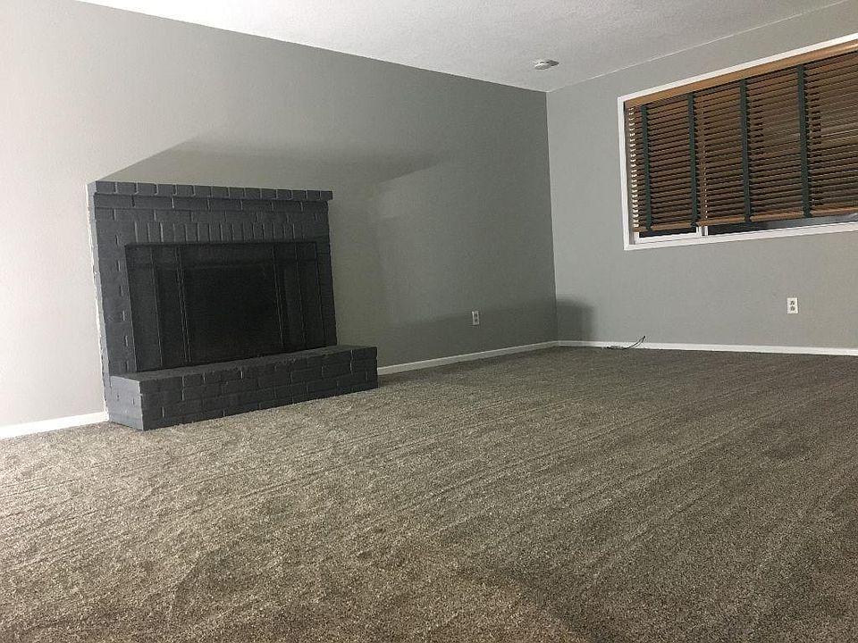 Living room with large window. Fireplace is for ambiance only. Nonworking fireplace.