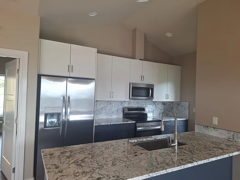 Full kitchen with INDUCTION cooktop, refrigerator, microwave, and dishwasher.