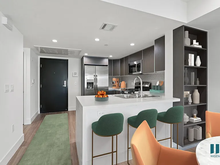 Kitchen with Stainless-Steel Appliances, Countertop bar, and Built-In Shelving