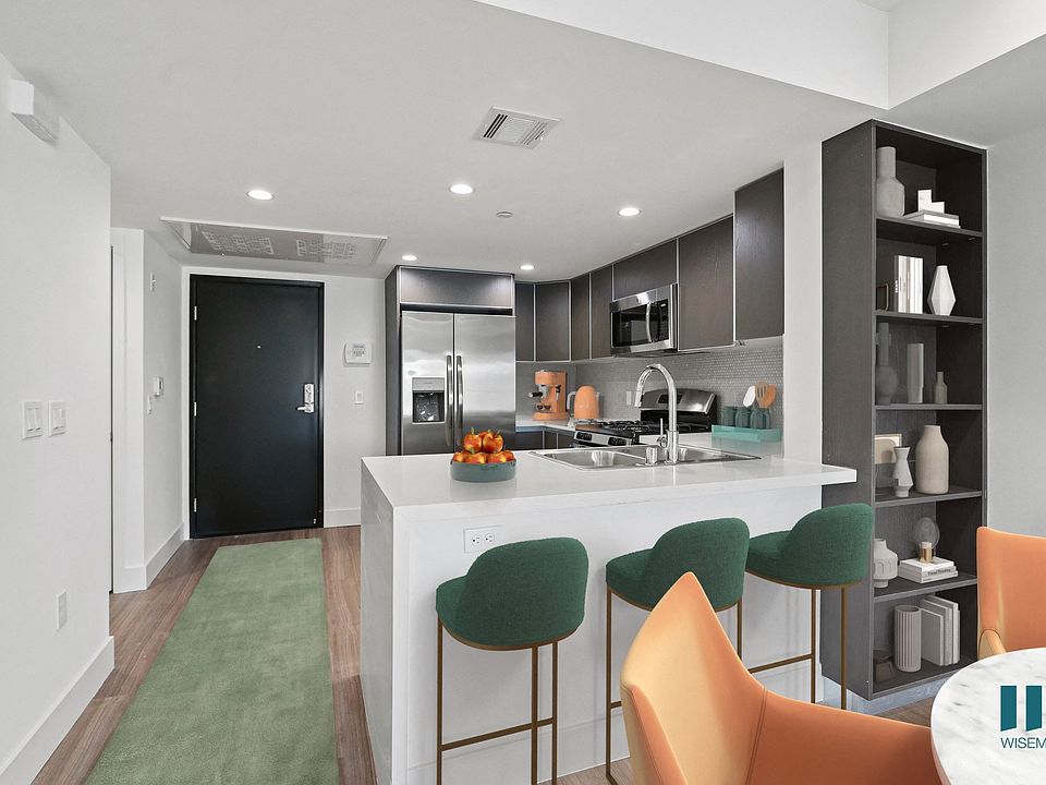 Kitchen with Stainless-Steel Appliances, Countertop bar, and Built-In Shelving