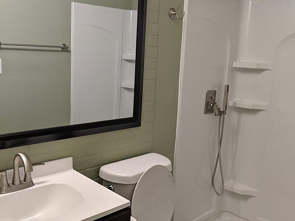 Brand new walk in shower, new toilet, vanity and tile