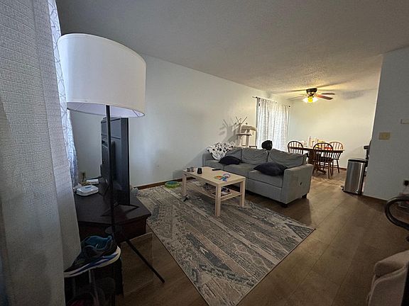 Open living room leading to dining room with a walkout to the deck