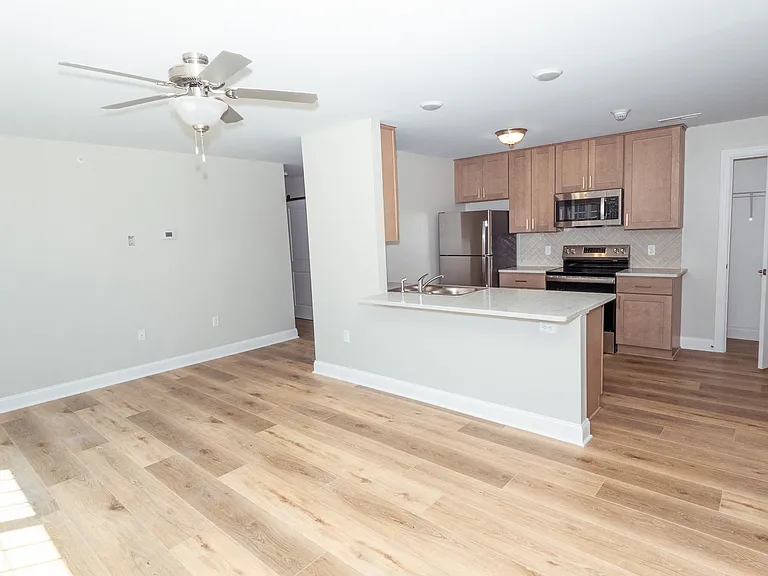 Wide Shot view of the kitchen and living room from the corner of the living room.