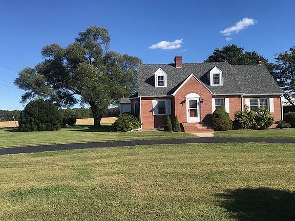 Front view of house and front yard with semi circle driveway