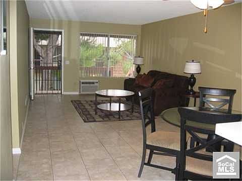 Lving room facing large window overlooking beautiful green grounds