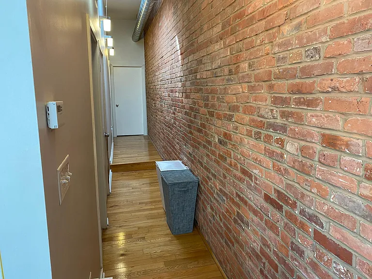 Hallway to bathroom and both smaller and larger rooms.