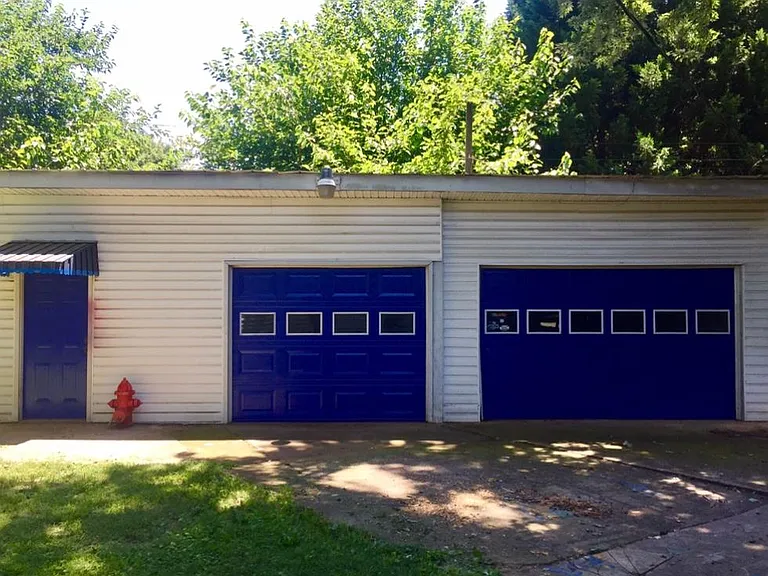 Two car garage / workshop with outlets for welding, welding bench and kilns.