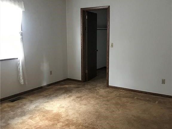Master bedroom with half bath and walk-in closet