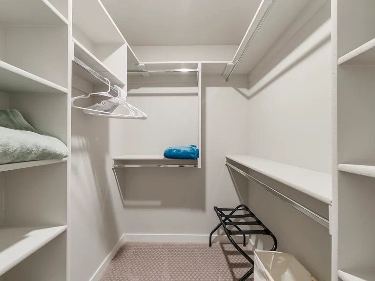 Master bedrrom walk in closet with plenty of room and shelving