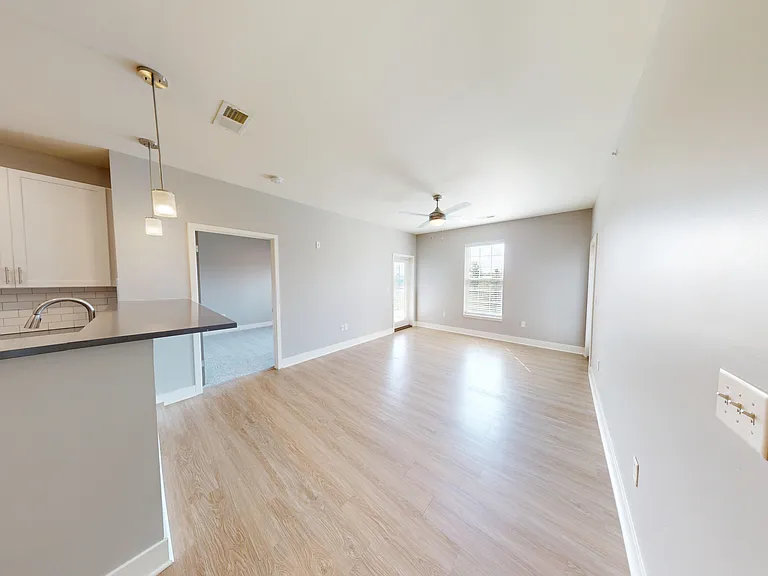 The Pleasant layout opens into a large living room with natural light and doors to two private patios or balconies. The Pleasant layout opens into a large living room with natural light and doors to two private patios or balconies.