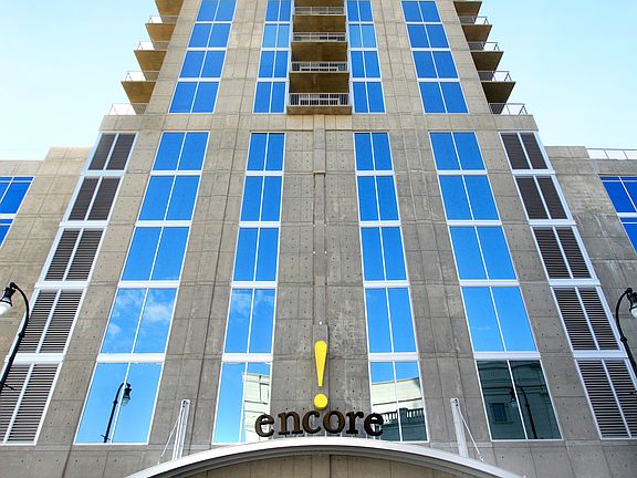 Encore A sleek, luminous presence of glass and white metal