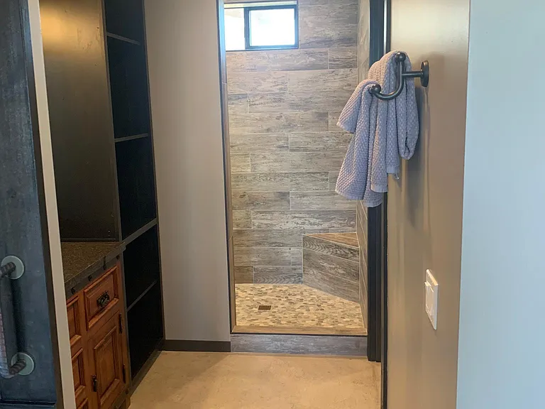 Spacious bathroom suite with walk in shower and custom vanity and cabinet.