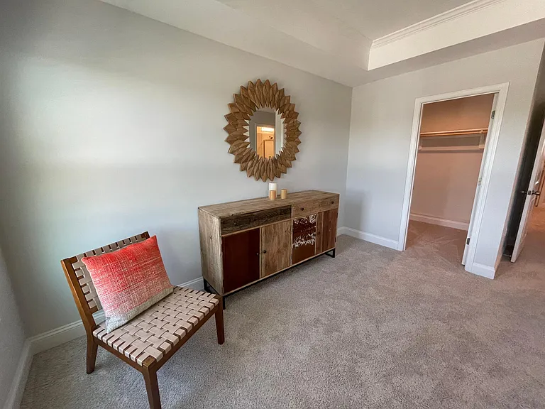 Sitting space and walk in closet within the master