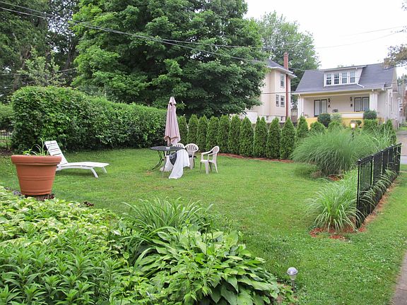 Fire pit area surrounded located in semi secluded area of yard.