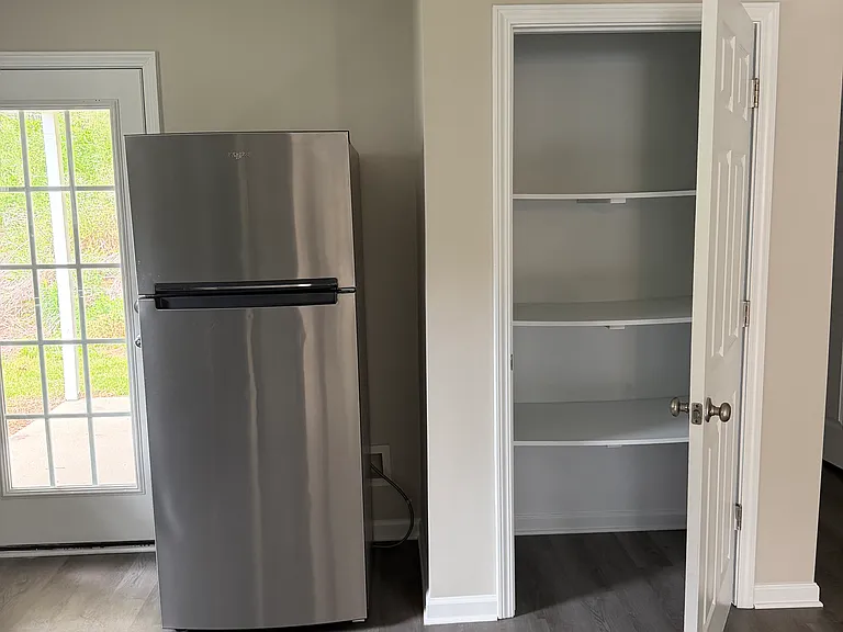 Back door to patio, refrigerator/freezer, pantry
