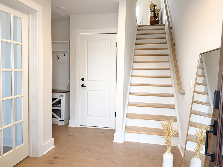 Entry foyer with stairs connecting all three floors