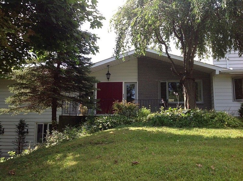 Front View
						:
						Front entrance features double doors and weeping cherry tree.