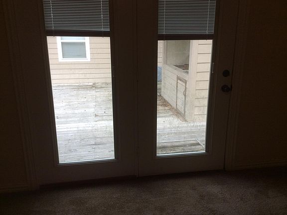Master bedroom overlooks deck, outdoor grill and storage roo