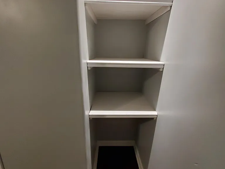 Master bedroom has lighted, custom shelves and USB charging station outlets.