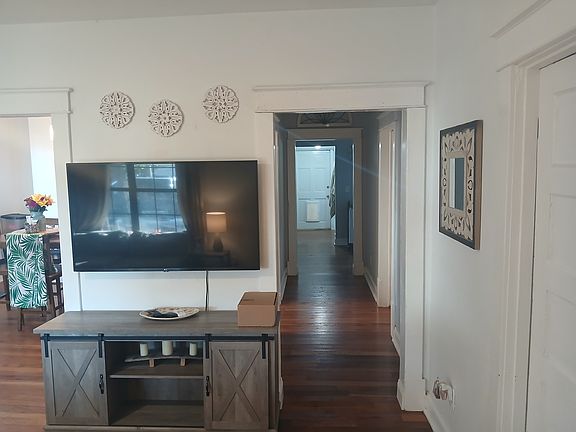 Living Room. Bedroom one is to the right. Hallway leads to the 2nd bedroom, bathroom, and laundry room.