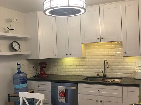 Kitchen. New counter and cabinet, ceiling light/fan combo.