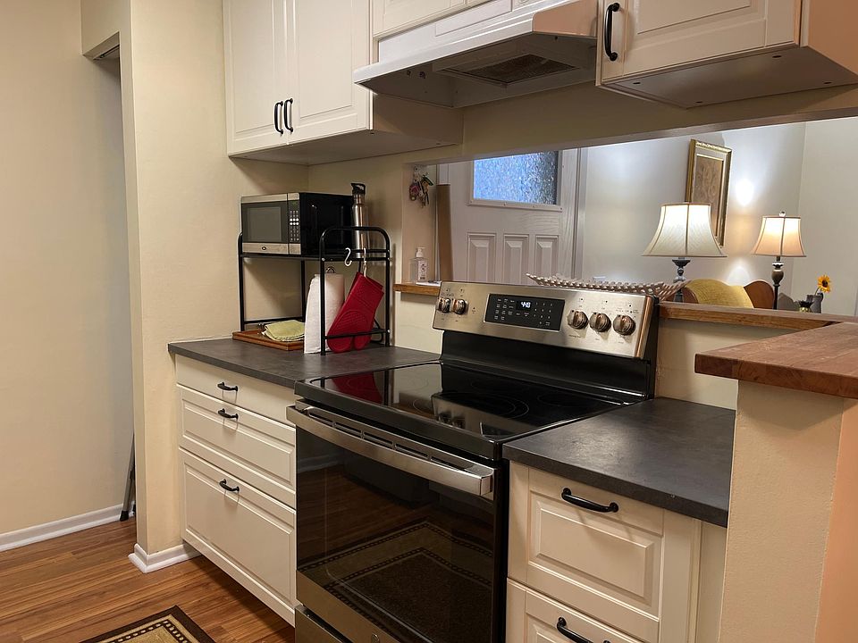 Kitchen with updated stove, pantry storage, open view of living room