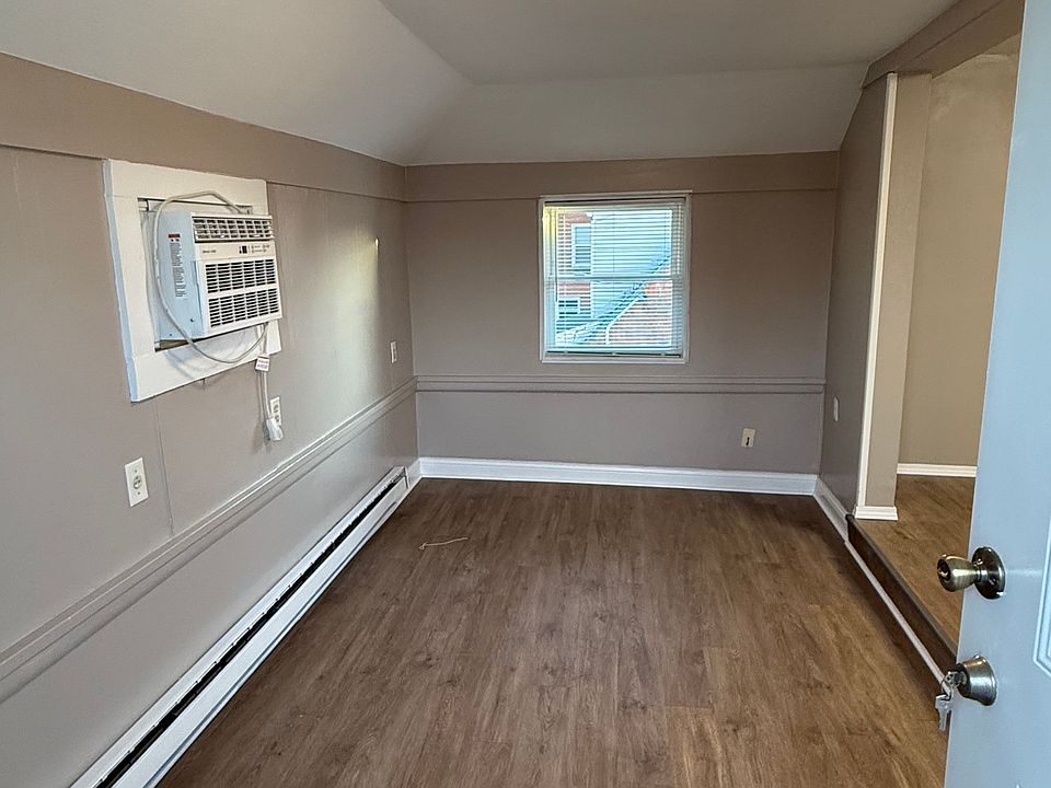 Living room area open to the kitchen. Has fresh paint and new flooring.
