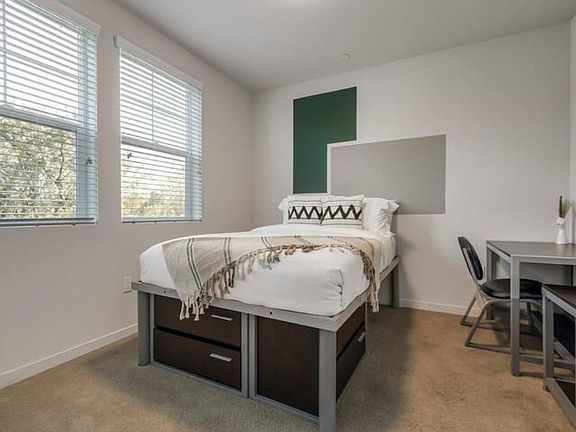 Get cozy! This room has a full-size bed with a desk and chair.