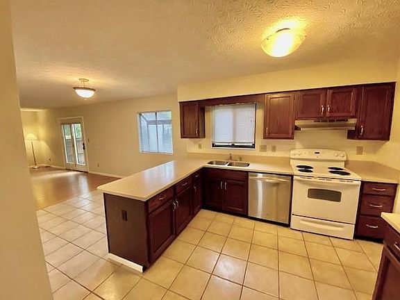 Kitchen and Eating Area, Family Room with door to Patio and Deck