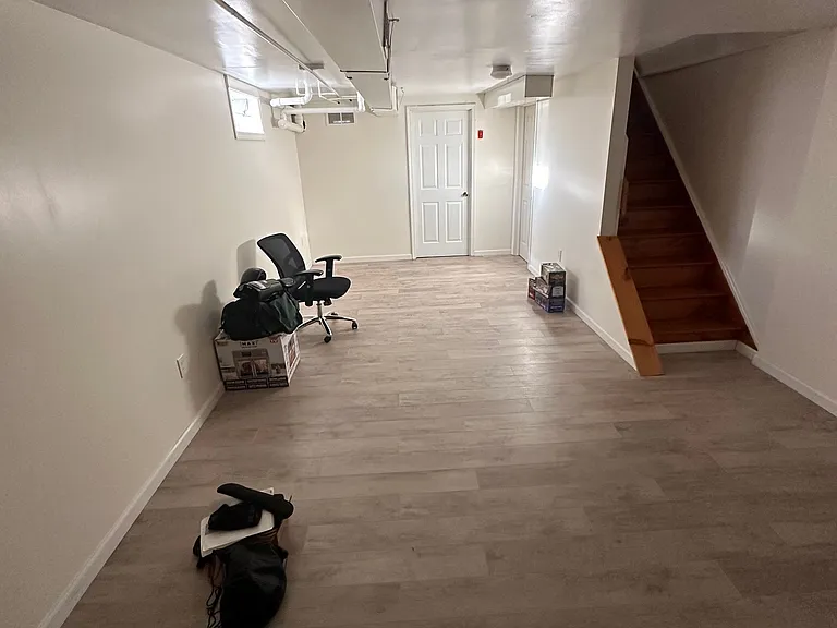 Basement and access to laundry room from the door accross