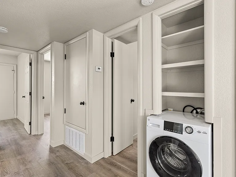 Washer/dryer combo in living room.