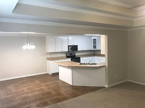 Living area with vaulted ceilings open to kitchen