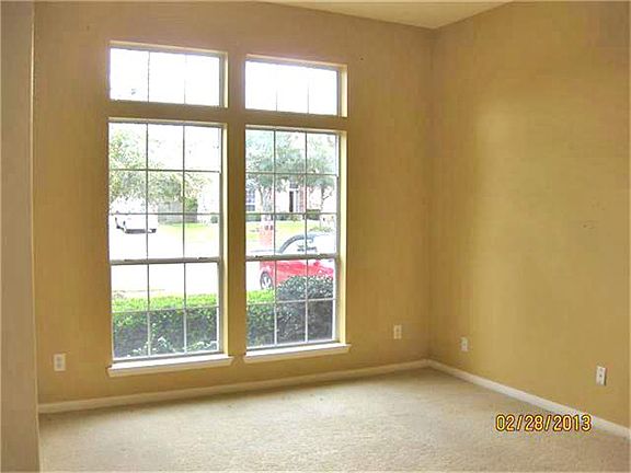 Study/Formal Living Room is bright with transom windows.